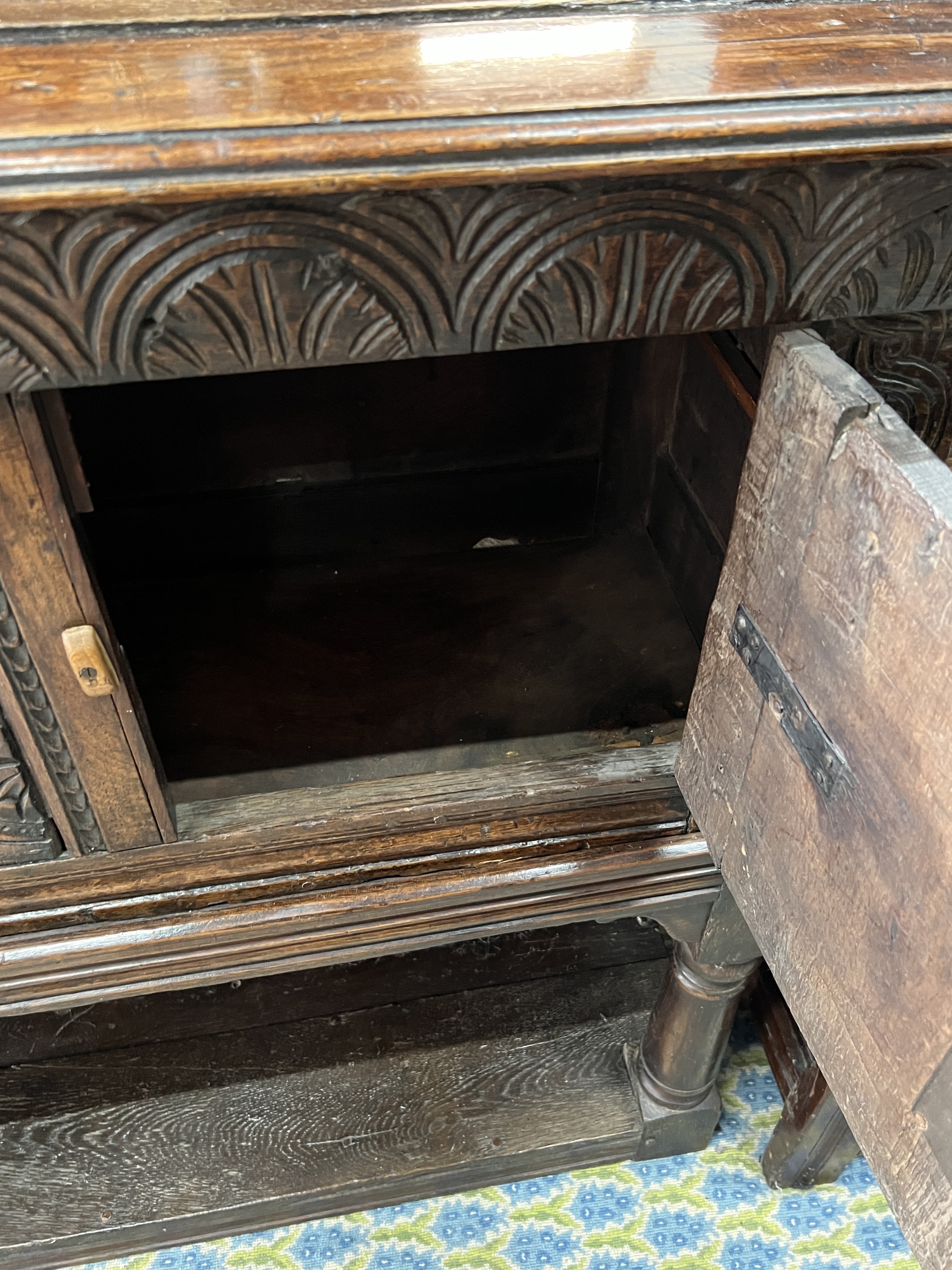 A 17th century and later carved oak potboard cupboard on stand, width 123cm, depth 43cm, height 111cm